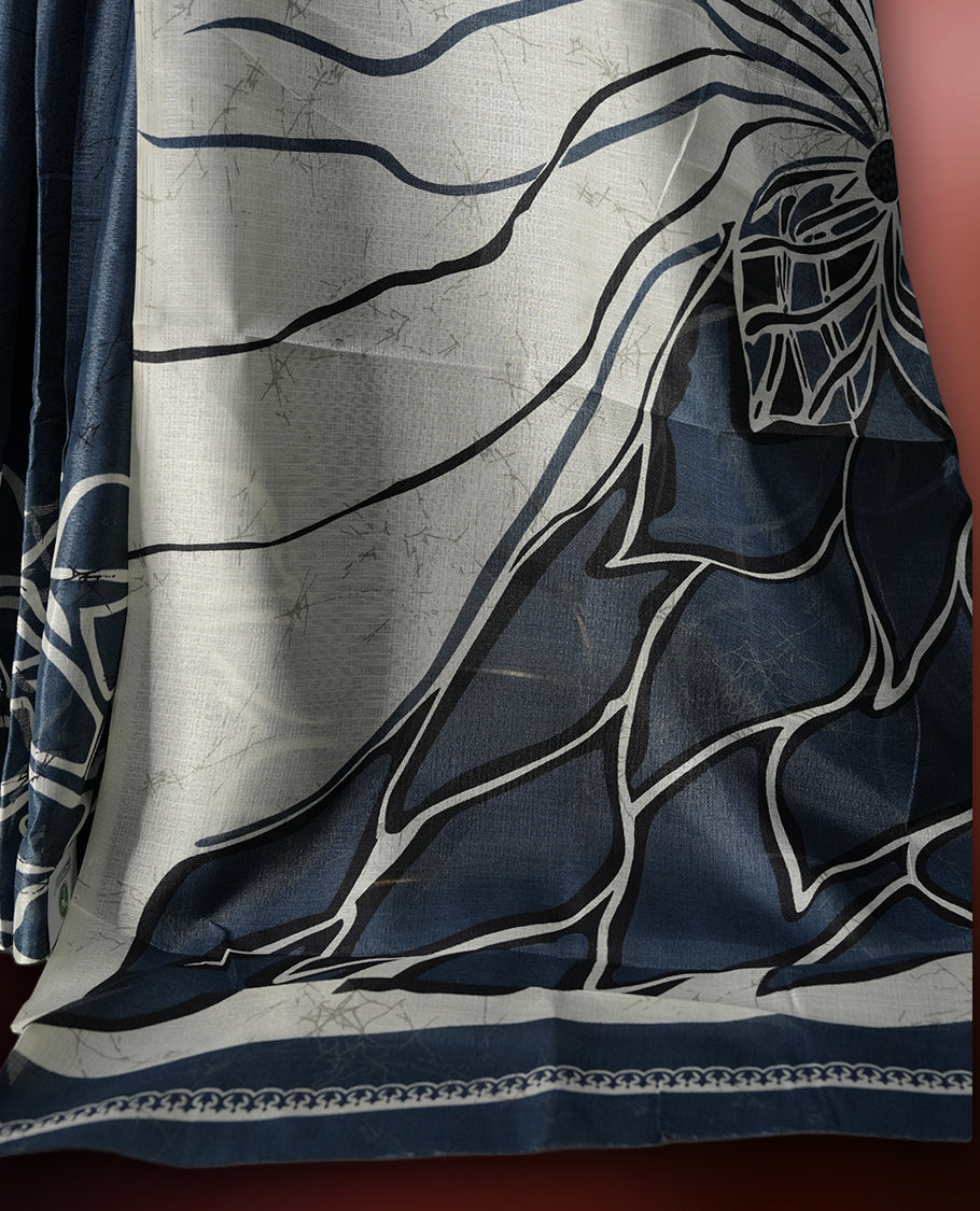 Grey and off white colour saree adorned with striking abstract floral designs, offering a perfect fusion of elegance and contemporary charm & paired with a matching blouse.