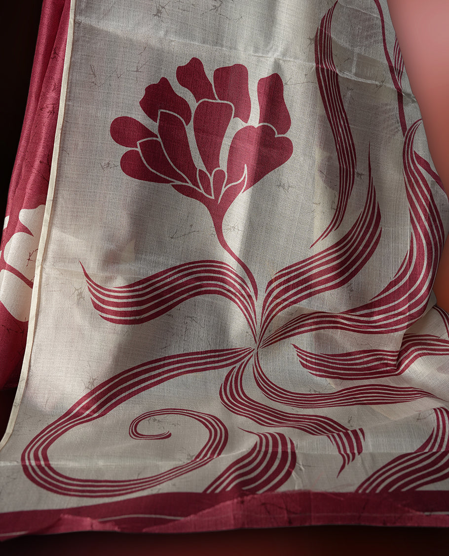 Cream and maroon colour saree with bold abstract floral patterns and a striking pallu design, blending modern artistry with traditional charm, paired with a matching blouse.