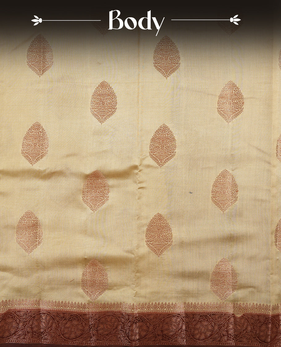 Cream beige Banaras soft silk saree with gold zari oval motifs on body, with contrast Chocolate brown colour floral pattern on pallu, border, and Matching blouse.
