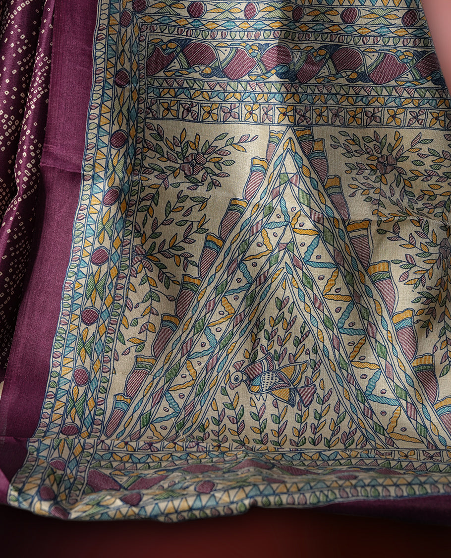 Dark grape colour saree adorned with intricate beige bandhani patterns and a contrasting pallu featuring exquisite beige floral motifs, perfectly paired with a matching blouse for a regal look.