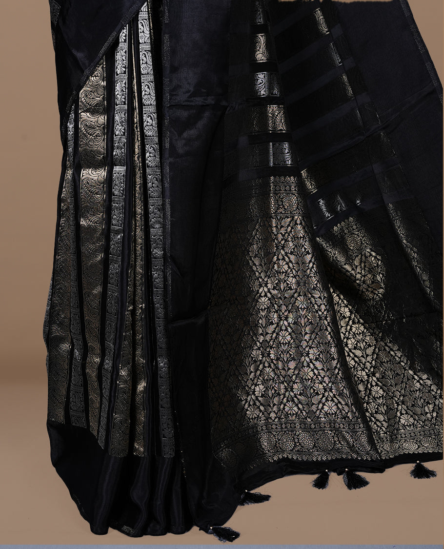 Black colour banaras crepe saree featuring gold & silver zari design stripes on body, complemented by self colour border, paired with matching blouse piece.