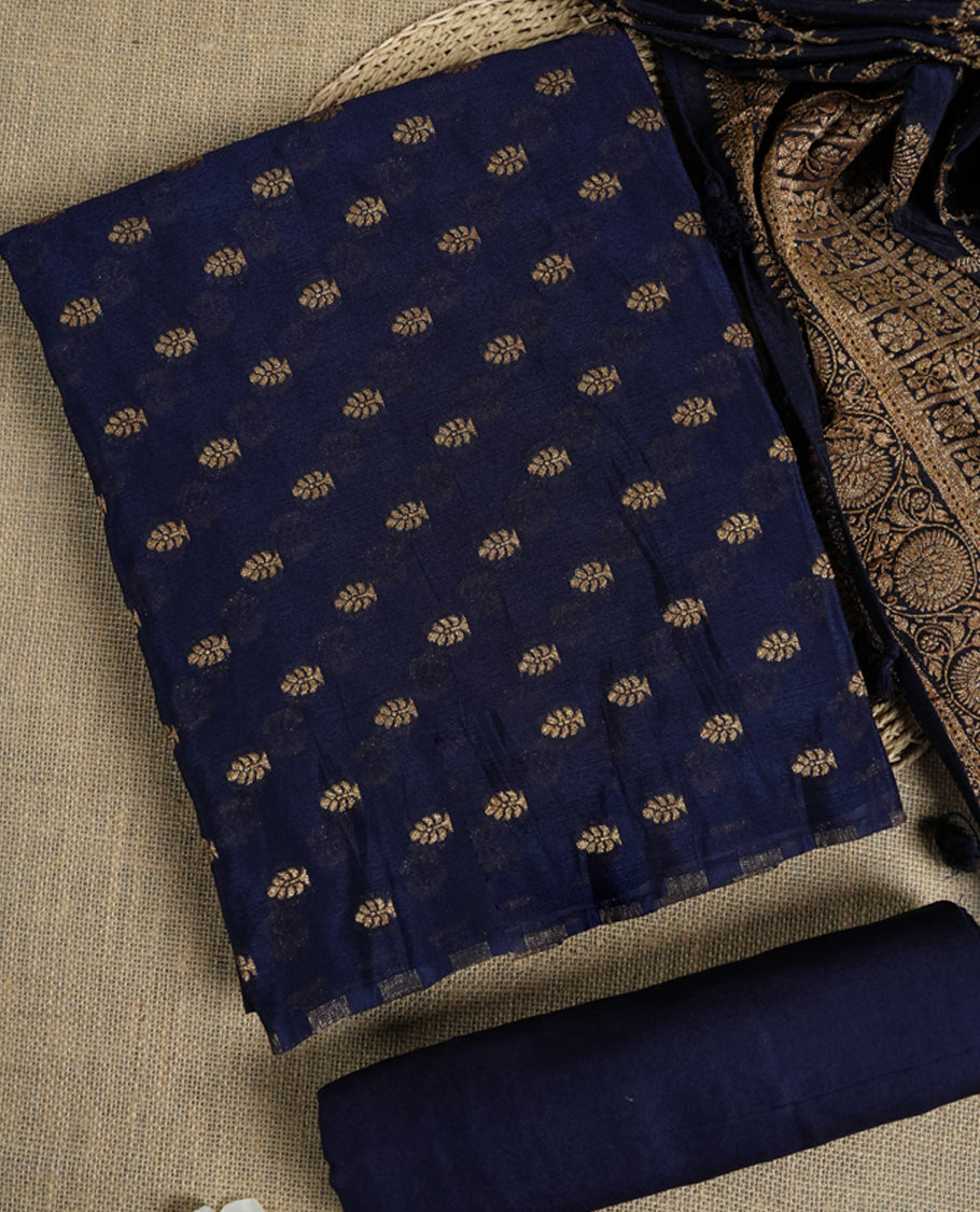 Navy blue colour suit material adorned with intricate golden zari weaving, exuding timeless elegance & Paired with a beautifully woven dupatta featuring floral and geometric motifs and a matching plain bottom.