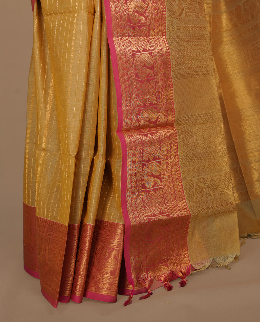 Beige colour chettinad saree featuring gold zari stripes on body, complemented by contrast Magenta colour with traditional border, paired with matching blouse piece.