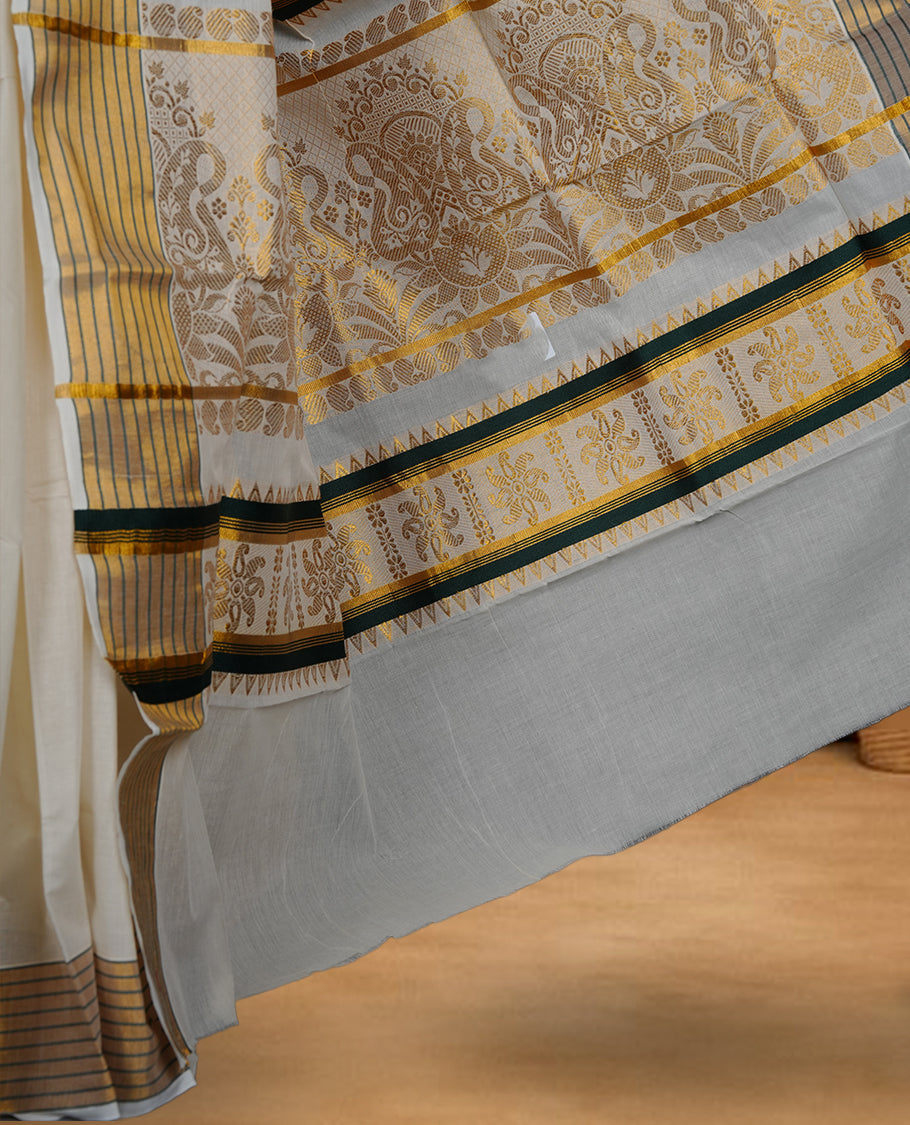 Off white cotton Kerala saree with a plain body and subtle motifs, striped golden zari border, and rich traditional pallu with green accents, paired with a matching blouse.
