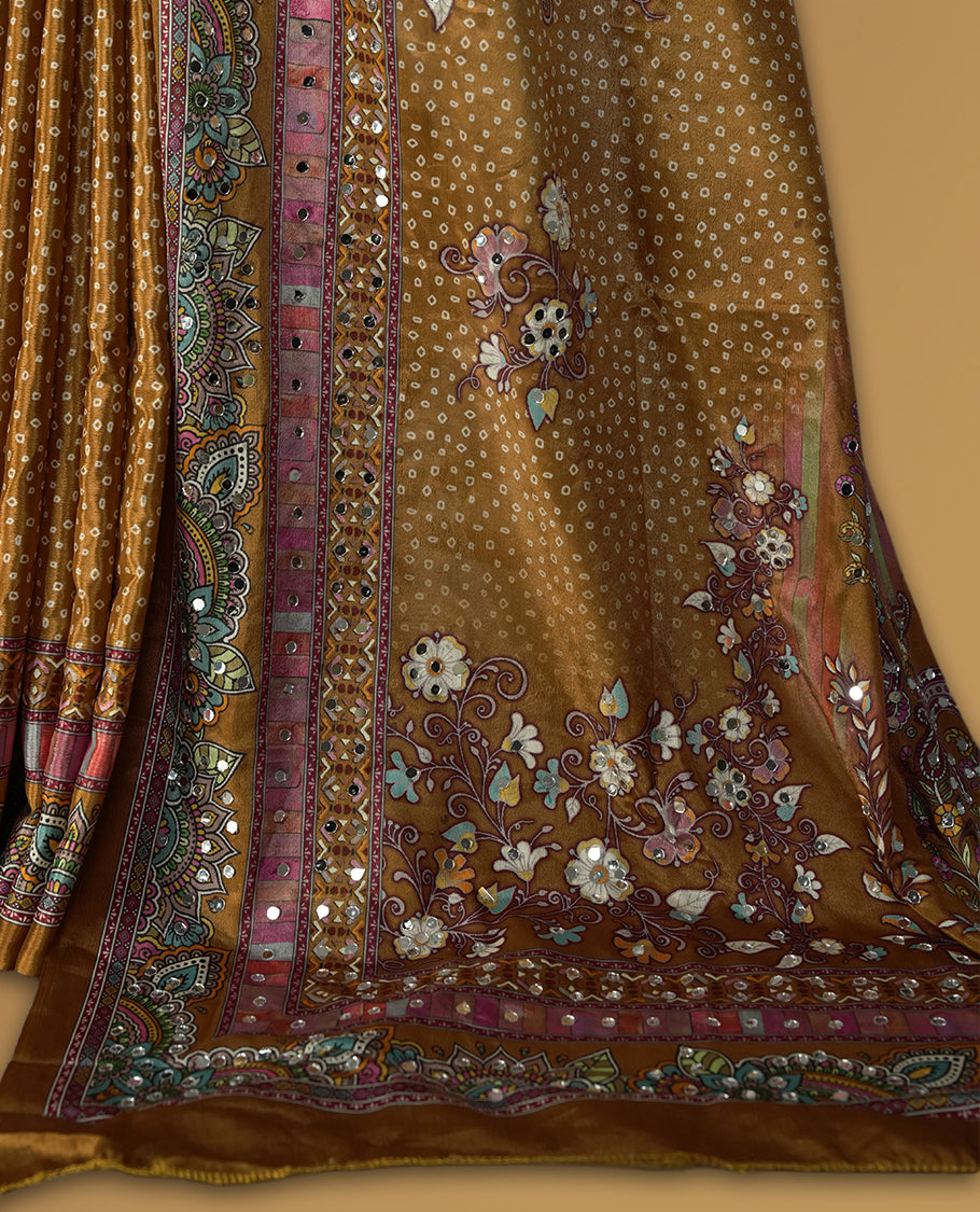 Mustard brown colour saree with intricate multicolor floral and paisley patterns, highlighted by vibrant borders & Paired with a matching blouse.