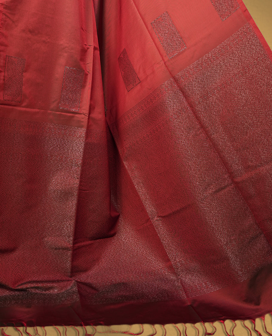 Dual tone medium copper & green semi soft silk saree adorned with woven square motifs on the body, complemented by a rich contrast woven pallu with tassel detailing & Comes with a matching blouse piece.