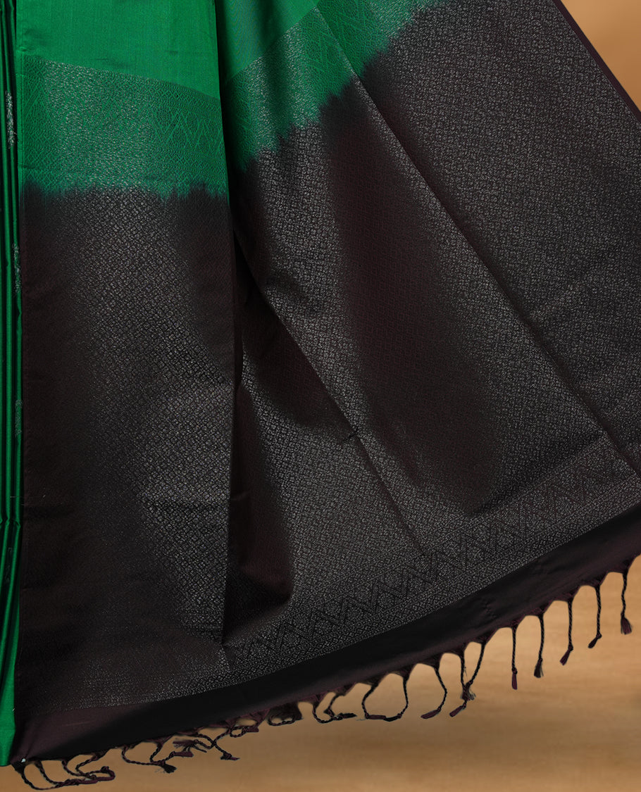 Green colour soft silk saree featuring Antique zari motifs on body with Highlighting contrast Deep Plum colour pallu and paired with matching blouse piece.