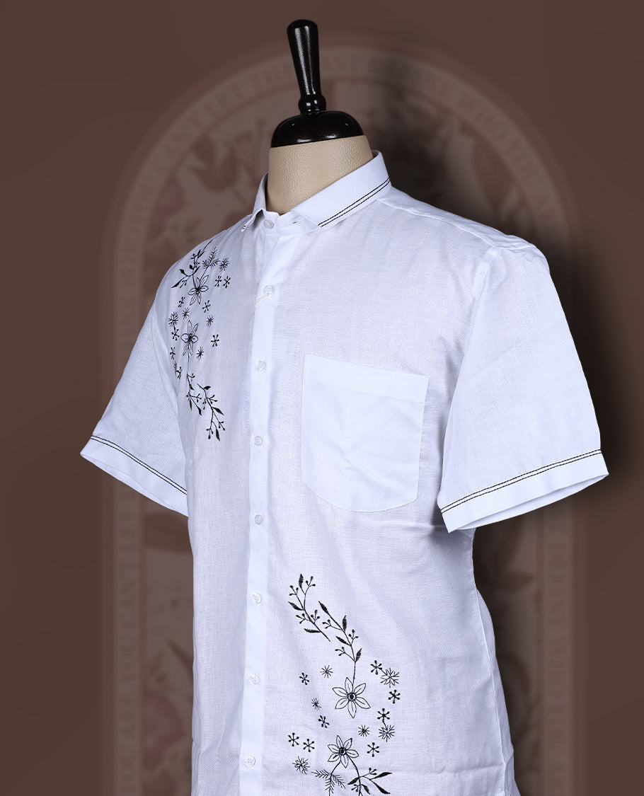 White colour Cotton linen shirt with black colour floral embroidery and smart short sleeves, Lightweight and breathable, perfect for casual or semi formal looks with an artisanal touch.
