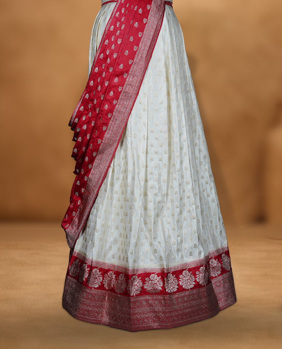 Off white semi banaras semi stitched dhavani set featuring gold zari motifs and contrast red colour and traditional border, unstitched gold zari blouse piece and matching Duptta.