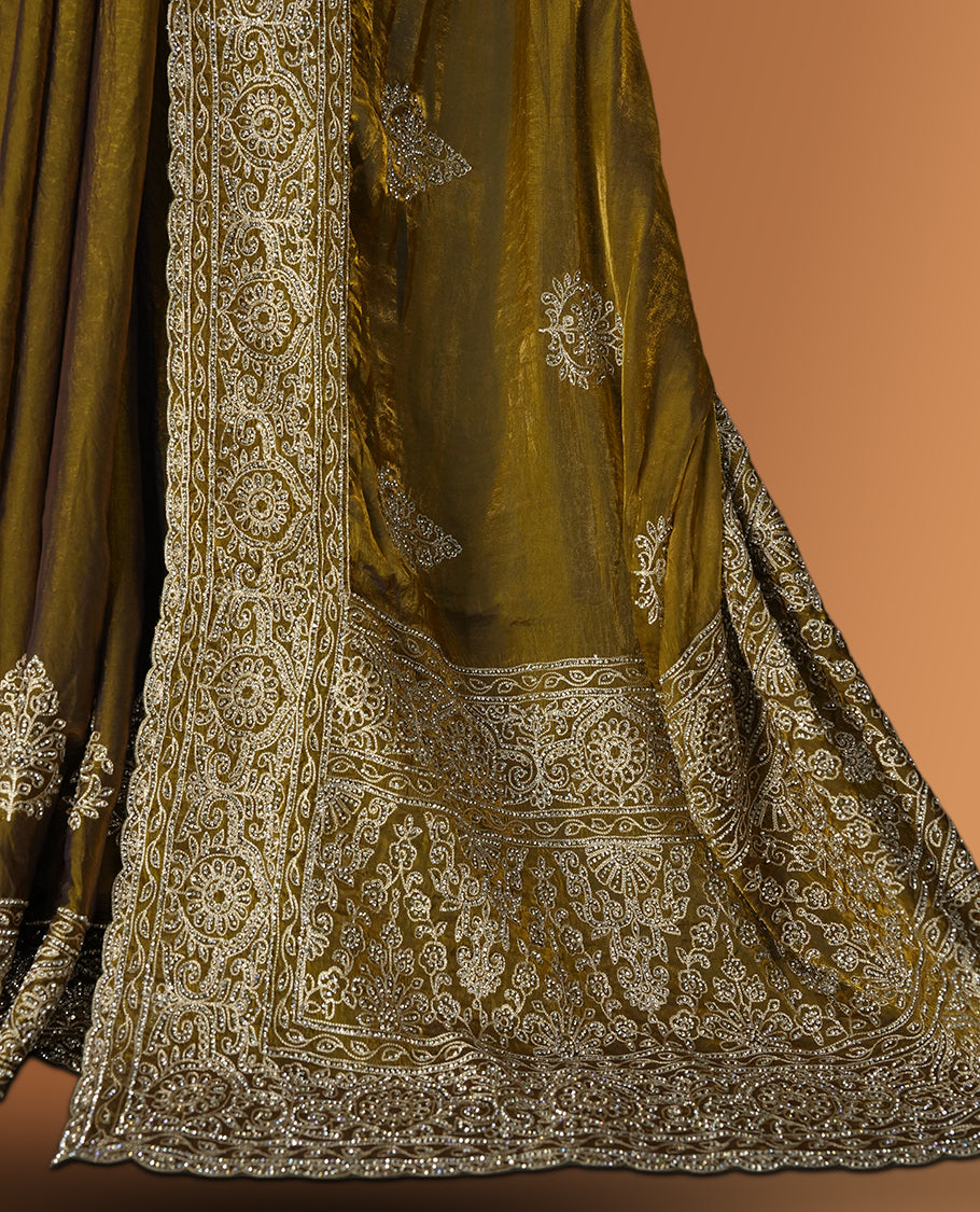 Dark yellow colour velvet chiffon designer saree in elegant two tone shades, featuring light gold zari, kodi work with handwoven style thread aari & dori embroidery work, Swarovski stone work and all over motifs, comes with matching blouse.