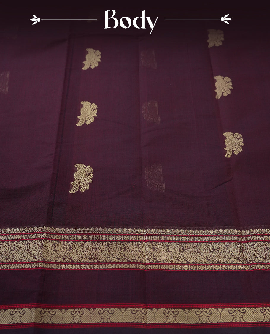 Deep maroon colour pure Kanchi cotton saree adorned with subtle beige zari motifs across the body, The intricate zari woven border adds a touch of tradition & Includes a matching blouse piece for a complete look.