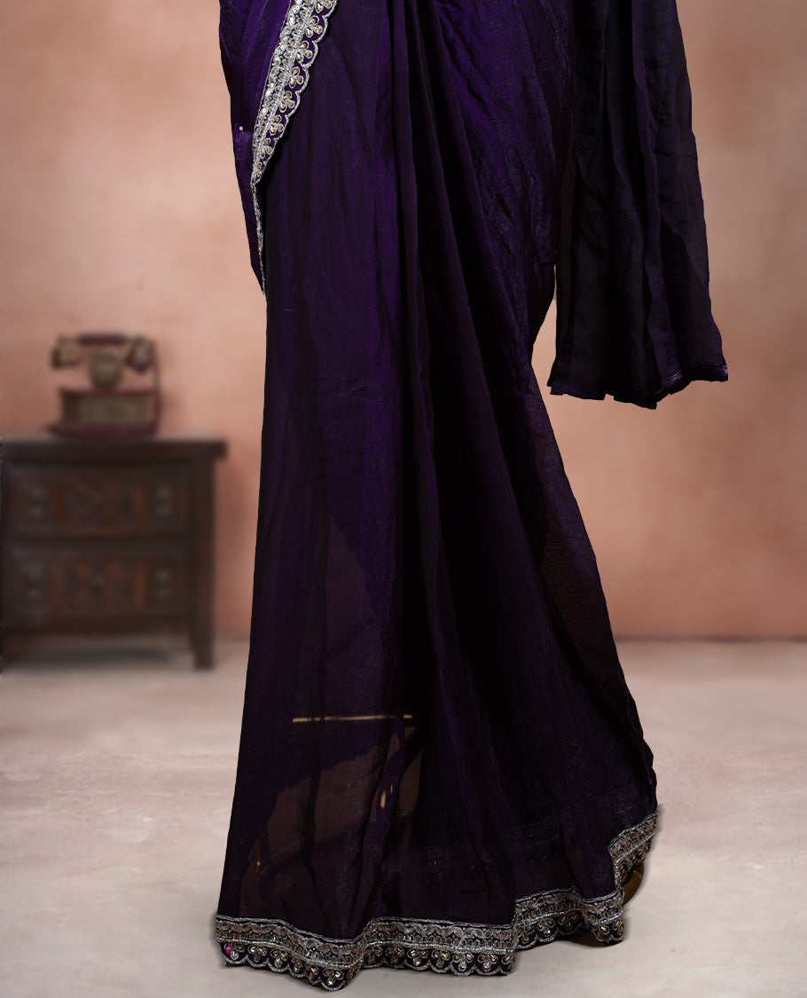 Elegant Royal purple ready to wear saree adorned with rich silver zari and bead embroidery along the border and pallu, paired with a heavily embellished matching blouse for a grand festive look.