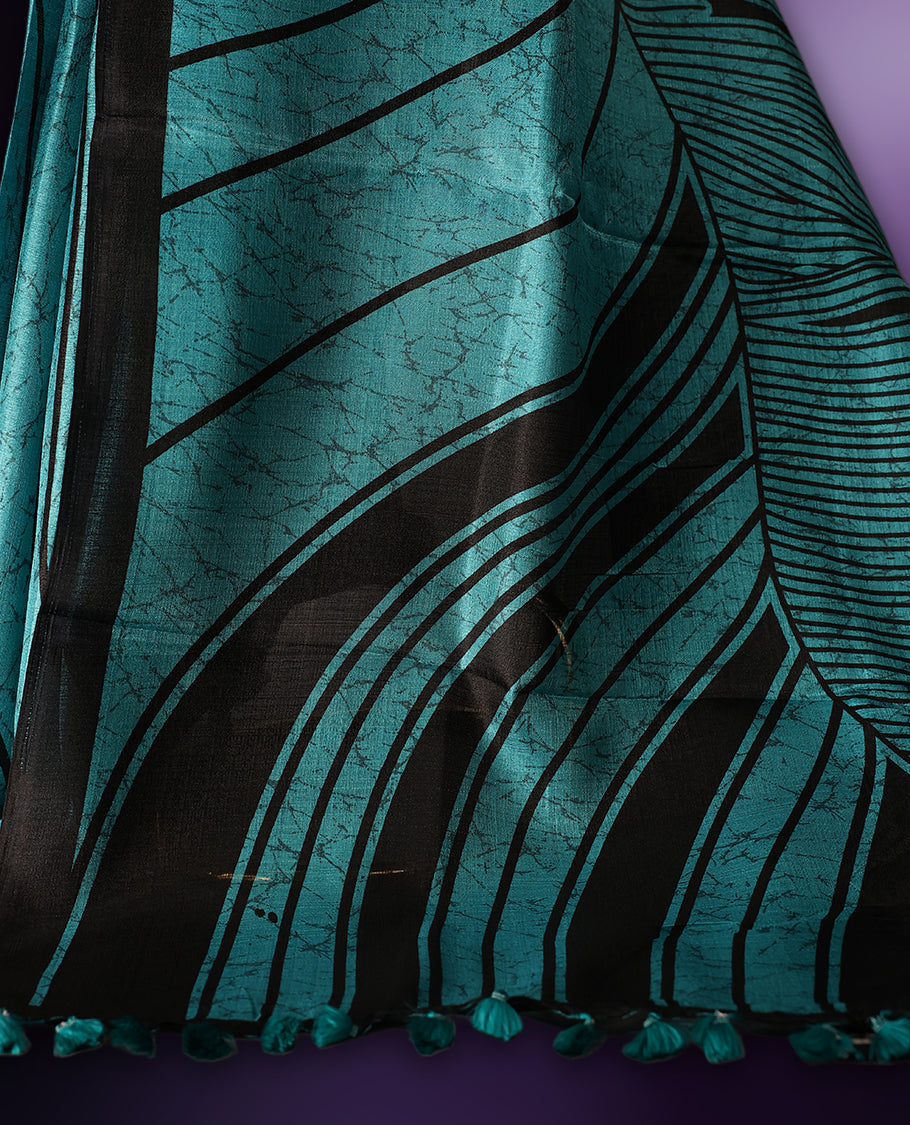 Elegant teal and black saree with abstract stripes and tassel detailed pallu & Perfect for festive and party occasions. Includes unstitched blouse piece. Style with minimal jewelry for a chic look.
