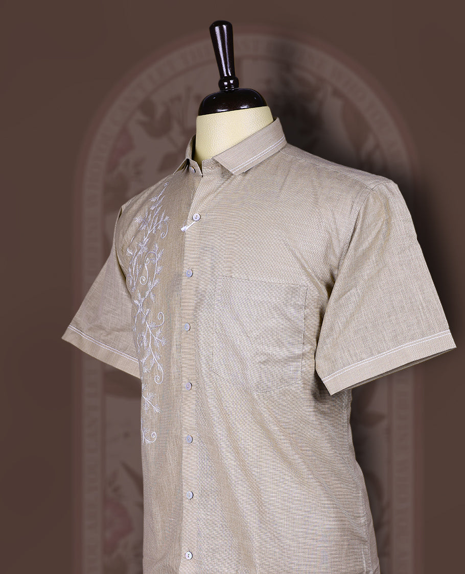 Taupe cotton linen short sleeve shirt featuring intricate white floral vine embroidery on the front, Designed with a mandarin collar and button-down style, blending artisanal detail with modern elegance.
