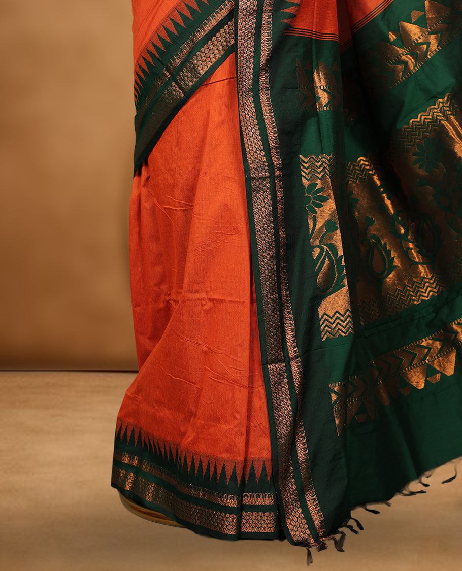 Orange colour kalyani cotton saree featuring Antique zari motifs on body, contrast green colour border with geometric antique zari pattern, paired with matching blouse piece.