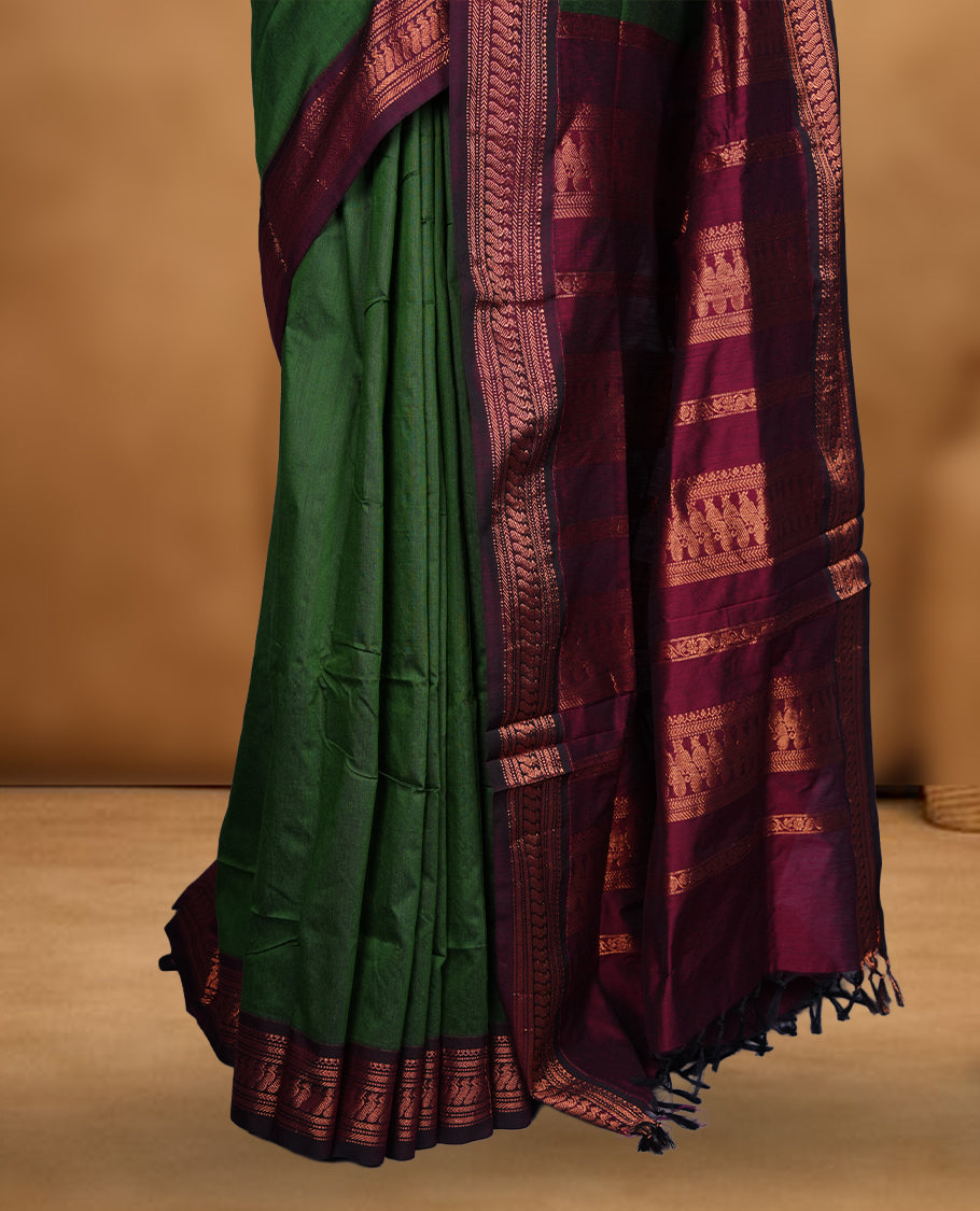 Green colour Kalyani cotton saree featuring a plain elegant body, complemented by a deep maroon border and traditional woven pallu, paired with a matching blouse.
