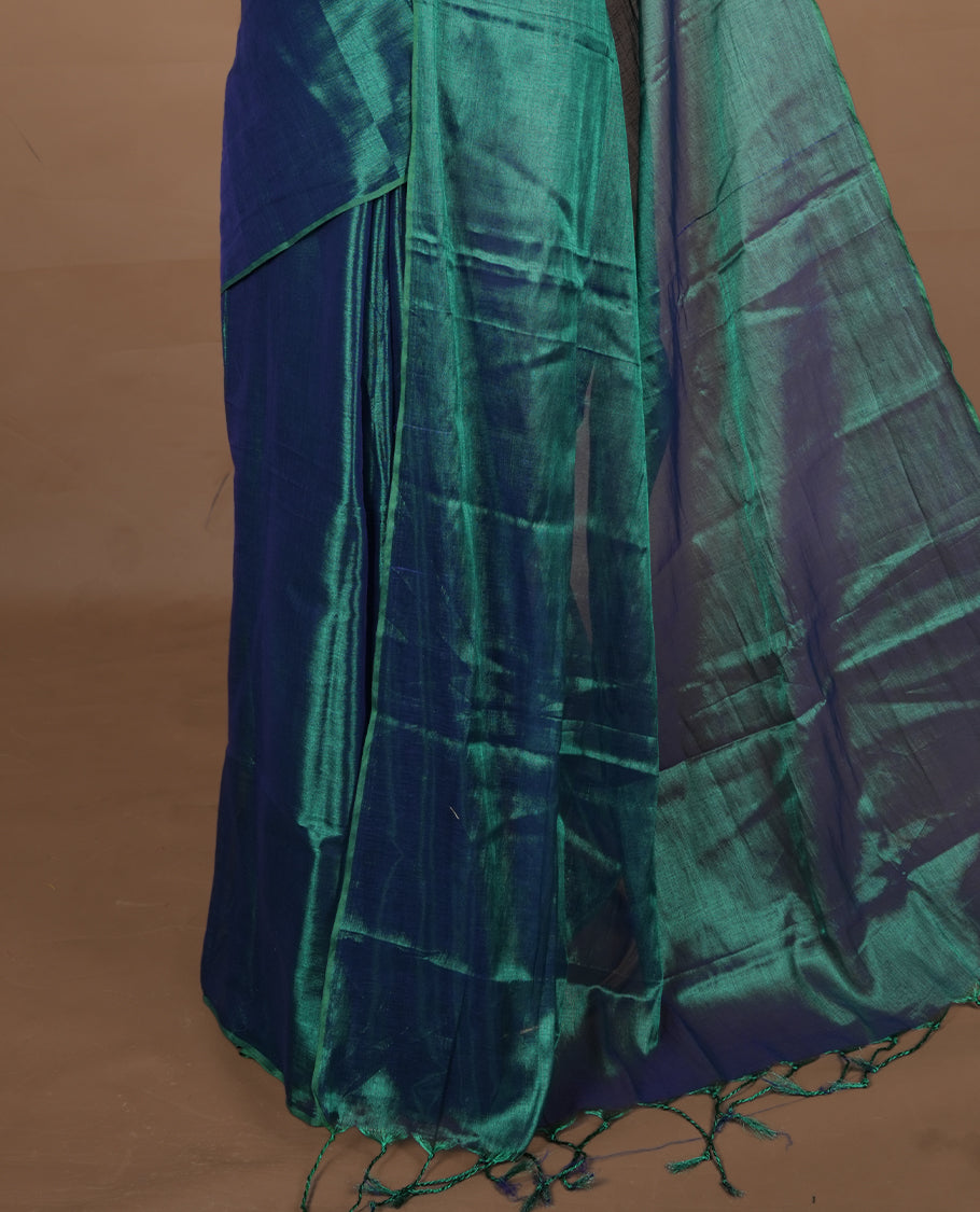 Peacock Green colour semi tissue saree featuring an elegant plain body, designed without a border and comes without a blouse piece.