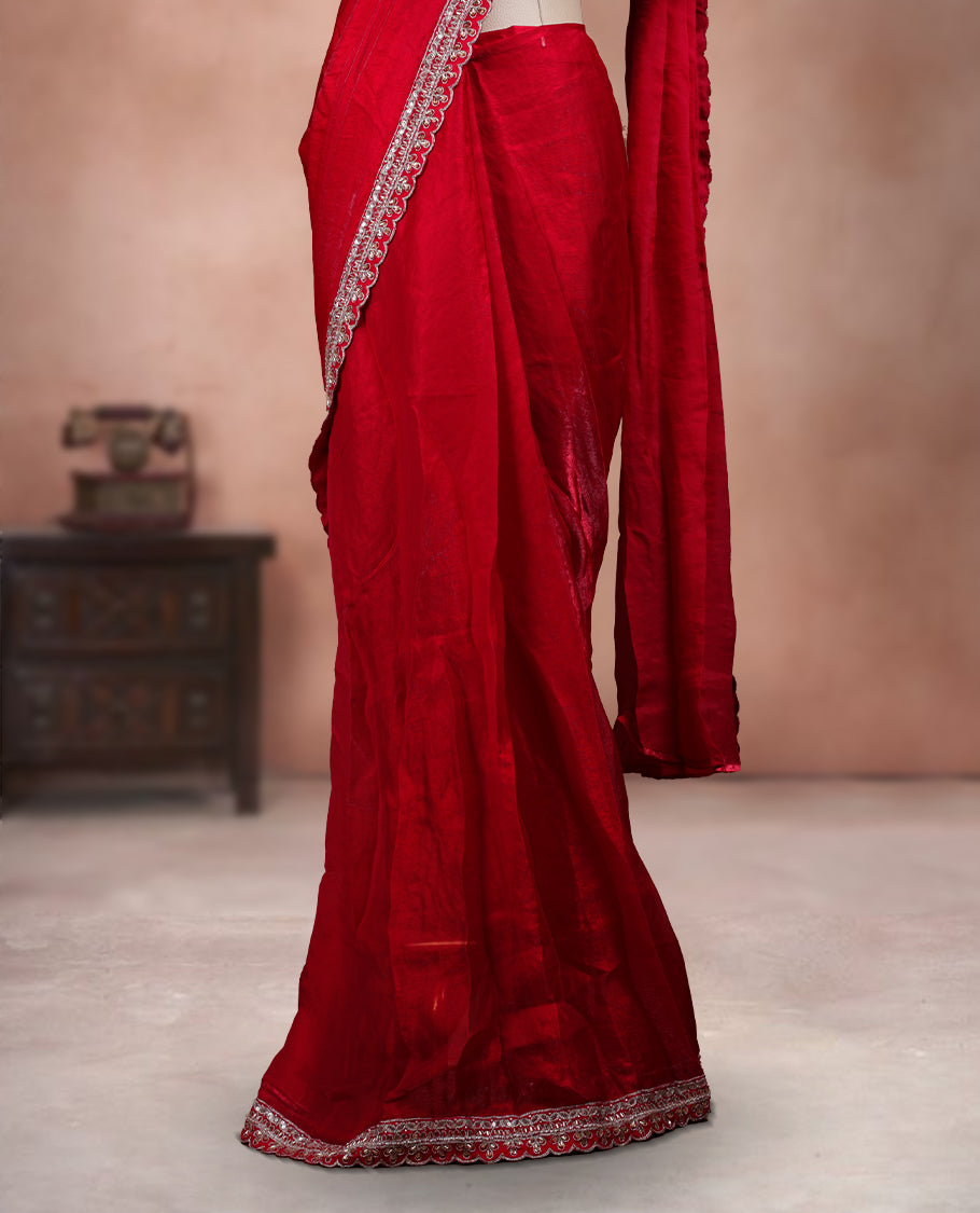 Elegant Bright Red Colour ready to wear saree adorned with rich silver zari and bead embroidery along the border and pallu, paired with a heavily embellished matching blouse for a grand festive look.