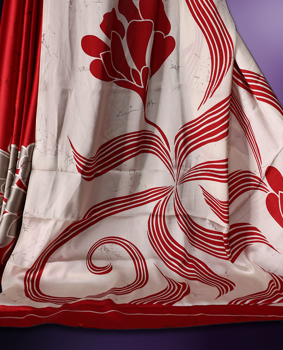 White and red semi modal saree featuring bold floral and abstract patterns across the body and pallu, enhanced with a smooth drape and a matching blouse.