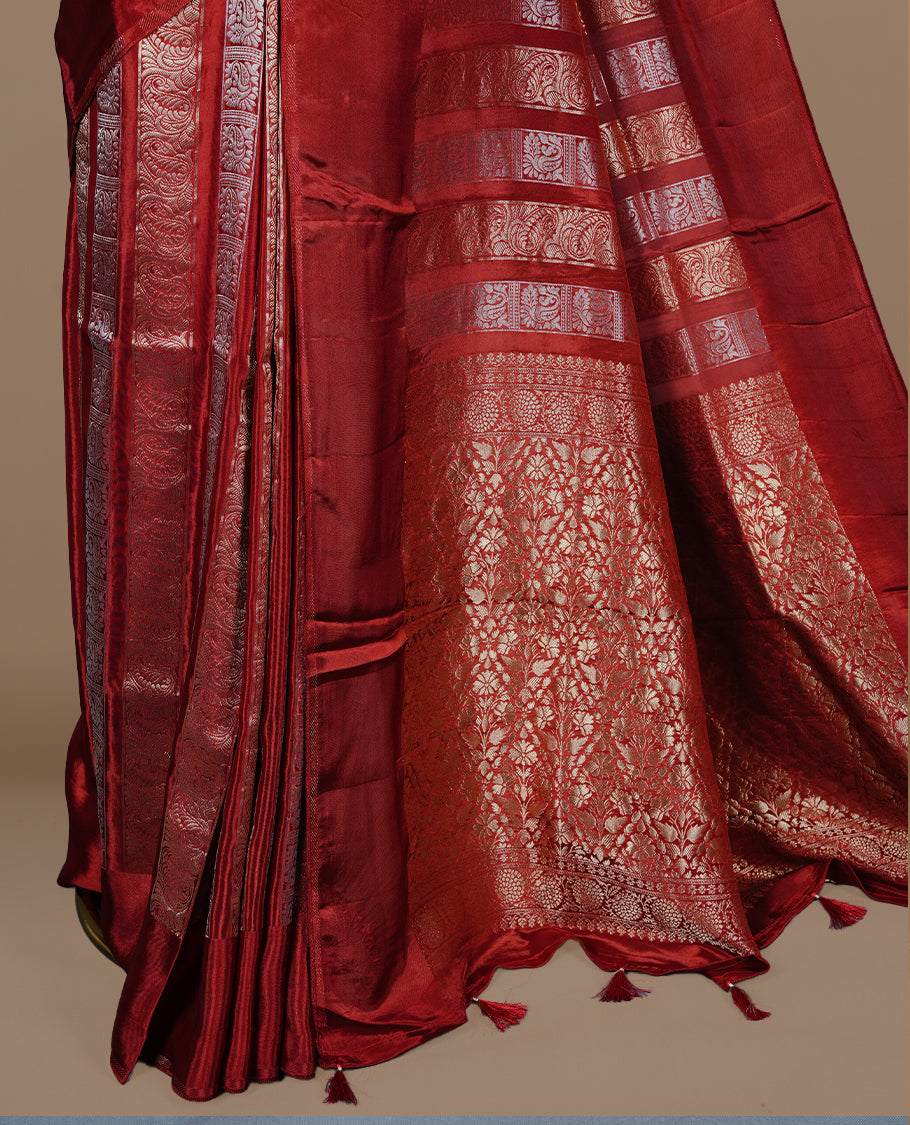Red colour banaras crepe saree featuring gold & silver zari design stripes on body, complemented by self colour border, paired with matching blouse piece.