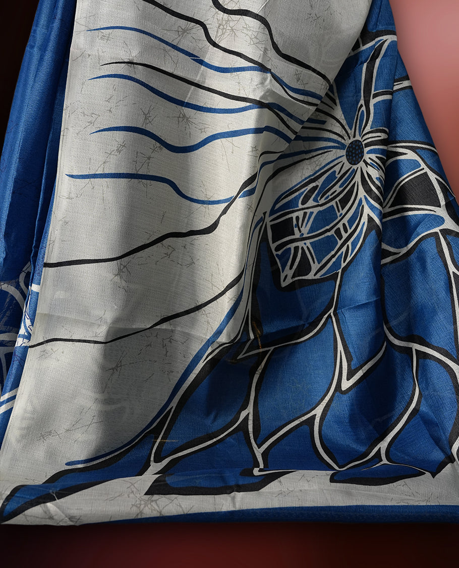 Blue and off white colour saree featuring bold floral patterns and contemporary artistry, bringing together tradition and modern style & paired with a matching blouse.