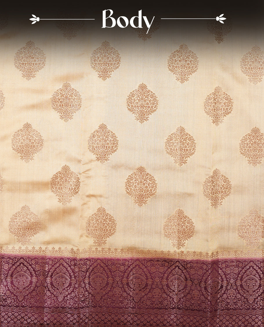 Cream beige Banaras soft silk saree with gold zari oval motifs on body, with contrast Maroon colour floral pattern on pallu, border, and Matching blouse.