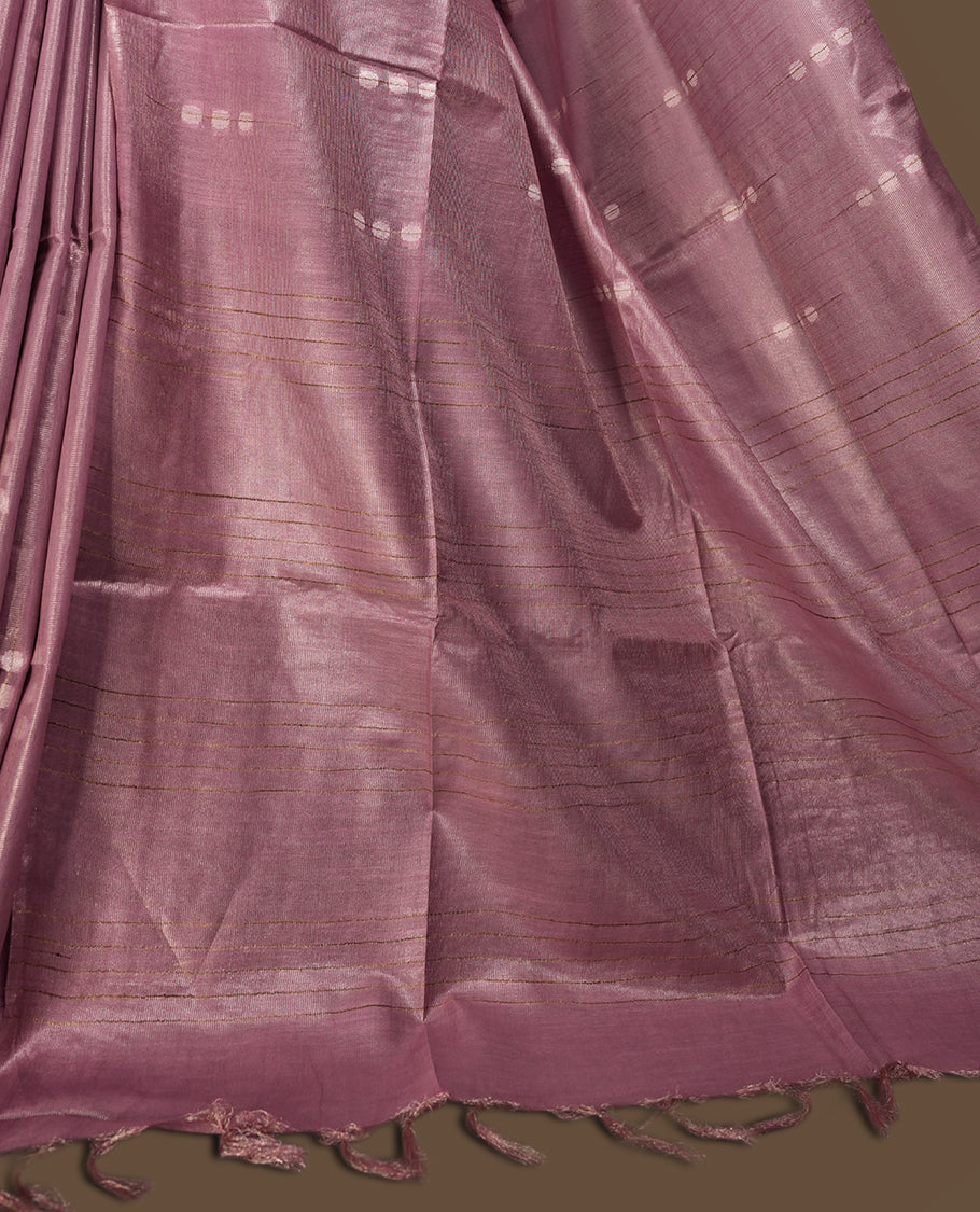 Soft Mauve colour semi jute tissue saree adorned with delicate dotted motifs all over, Features a finely woven pallu and sleek borders for a refined look & Comes with a matching blouse piece.