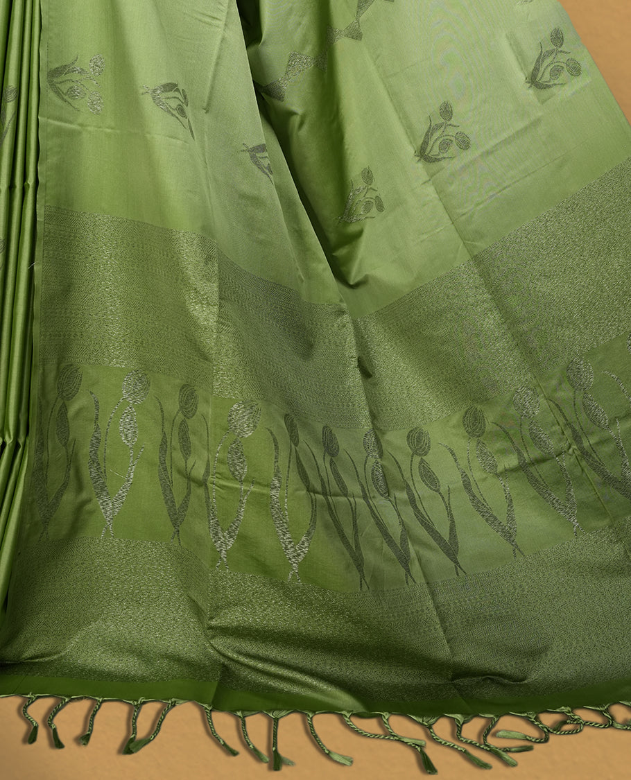 Pastel green colour semi soft silk saree adorned with delicate woven motifs on the body & Enhanced with a contrast zari border and elegant pallu with tassels, paired with a matching blouse.