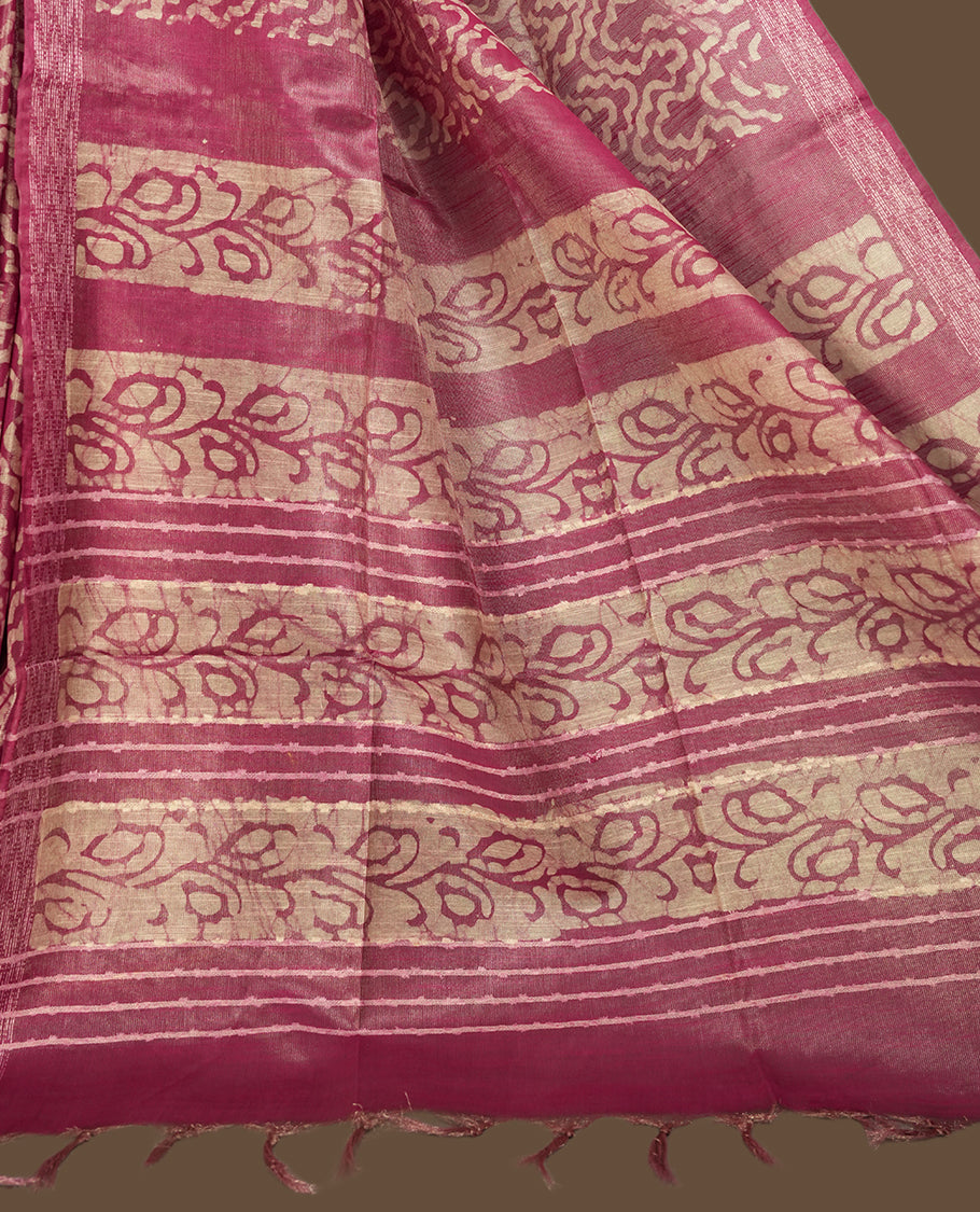 Pink colour semi jute tissue saree featuring delicate wave motifs on the body, complemented by a lustrous zari striped pallu and matching blouse piece for a refined festive look.