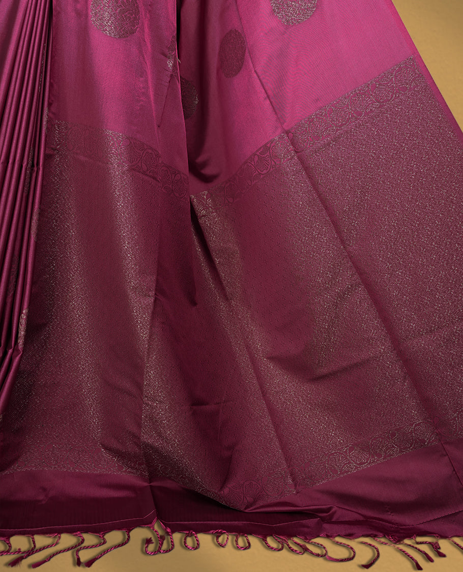 Soft Maroon colour semi soft silk saree adorned with woven circular motifs on the body, complemented by a rich contrast woven pallu with tassel detailing & Comes with a matching blouse piece.
