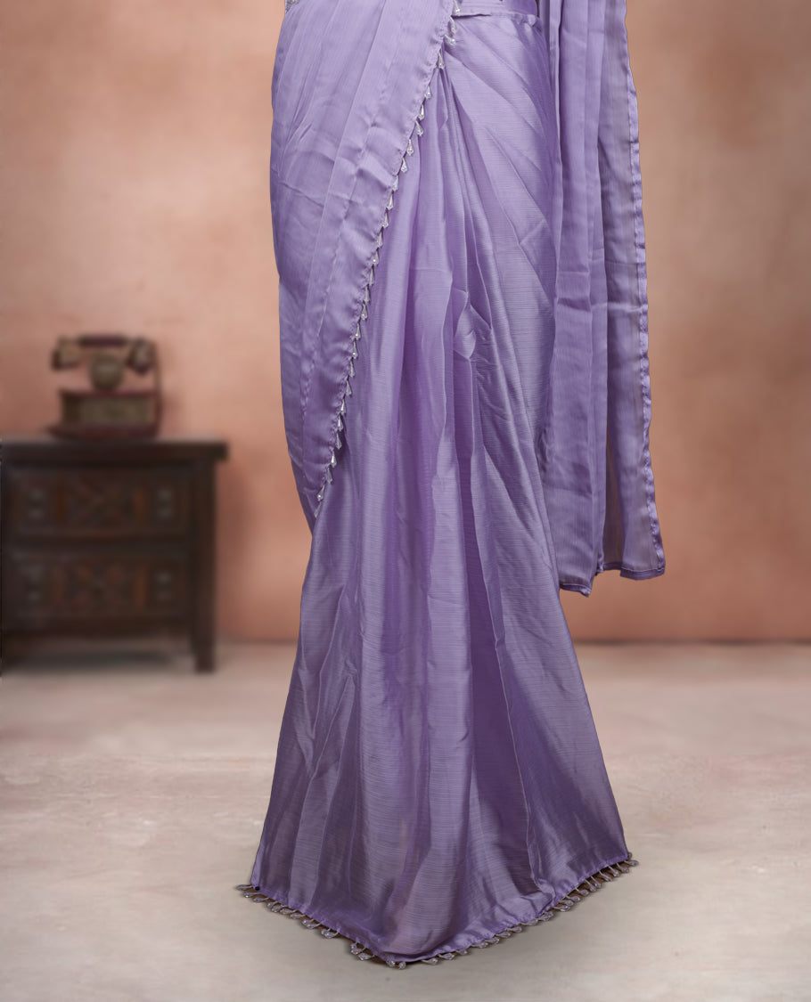 Elegant Lavender Colour ready to wear saree adorned with rich silver zari and bead embroidery along the border and pallu, paired with a heavily embellished matching blouse for a grand festive look.