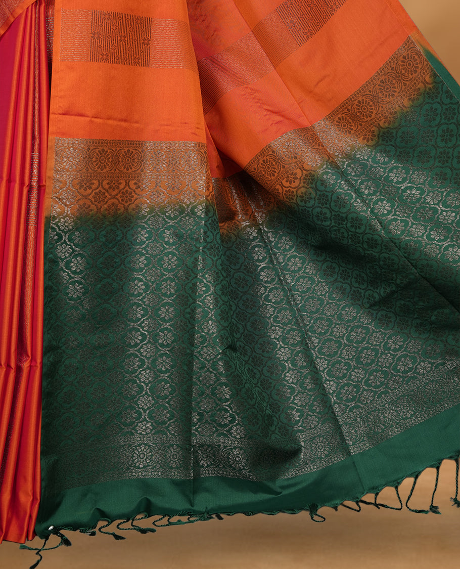 Burnt orange colour soft silk saree featuring Antique zari motifs on body with Highlighting contrast green colour pallu and paired with matching blouse piece.