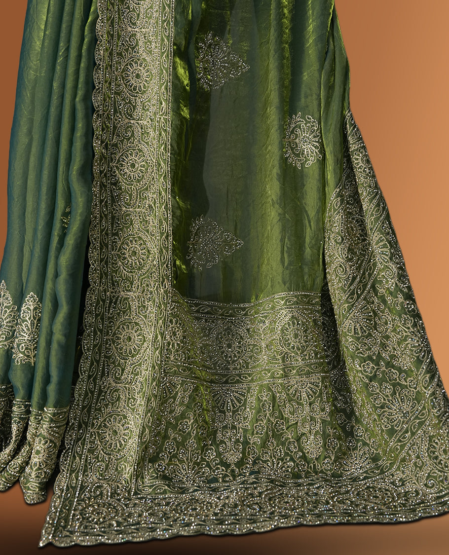 Asparagus green colour velvet chiffon designer saree in elegant two tone shades, featuring light gold zari, kodi work with handwoven style thread aari & dori embroidery work, Swarovski stone work and all over motifs, comes with matching blouse.