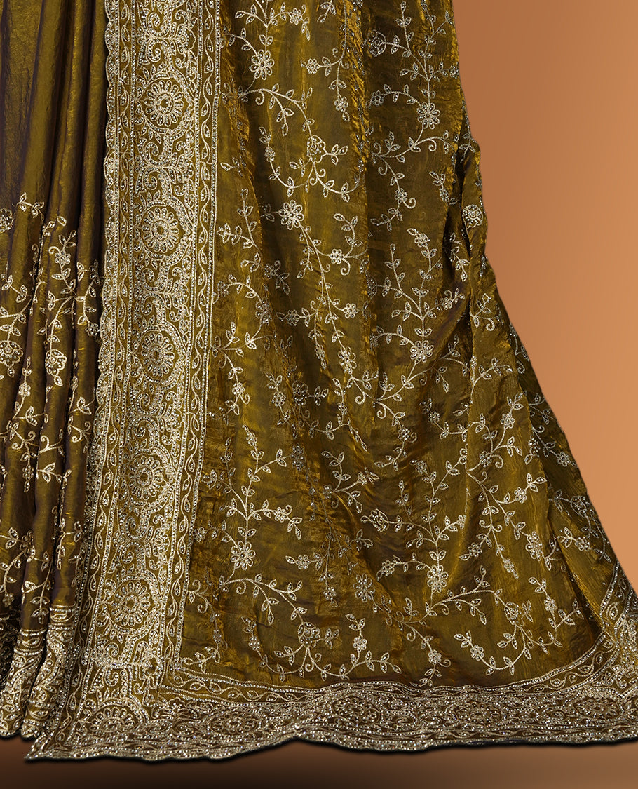 Mustard yellow colour velvet chiffon designer saree in elegant two tone shades, featuring light gold zari, kodi work with handwoven style thread embroidery, Swarovski stone work and all over motifs, comes with matching blouse.