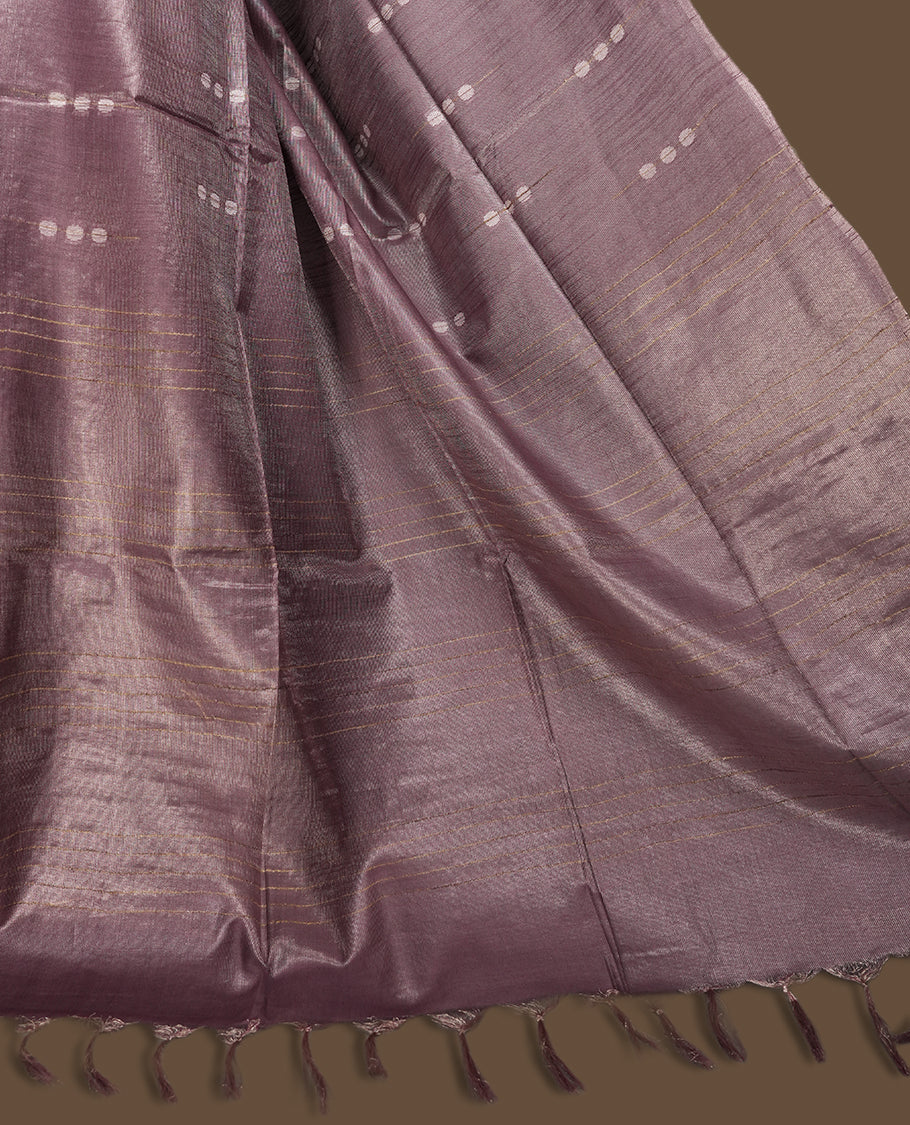 Mauve semi jute tissue saree featuring subtle dotted woven patterns on the body, complemented by a shimmering pallu and sleek zari border & Comes with a matching blouse piece for a complete look.