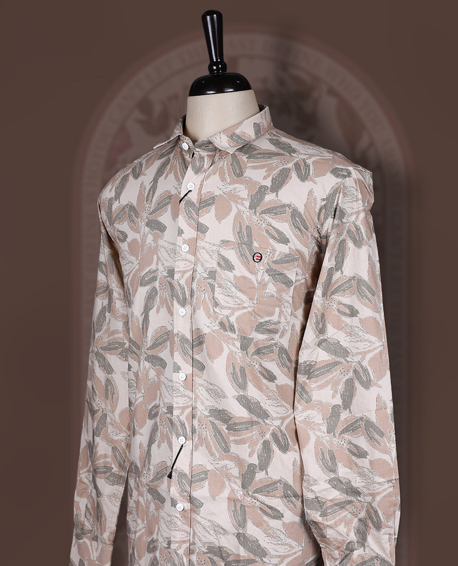 Cream colored shirt in soft cotton, featuring an all over leaf print in subtle earthy tones, Designed with a classic collar and roll up sleeves, it offers a perfect balance of tradition and ease.