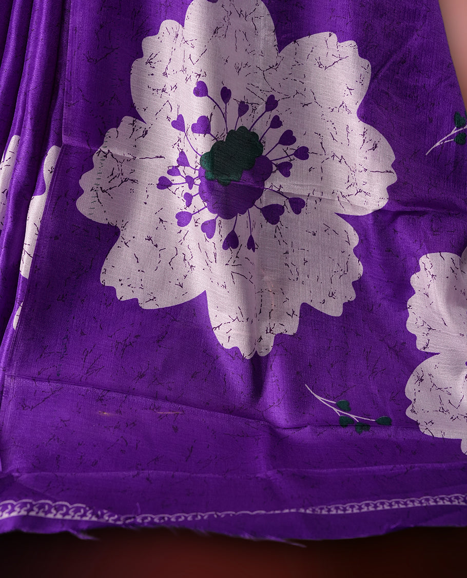Purple colour saree highlighted with bold white floral prints, blending contemporary style with ethnic grace and paired with a matching blouse.