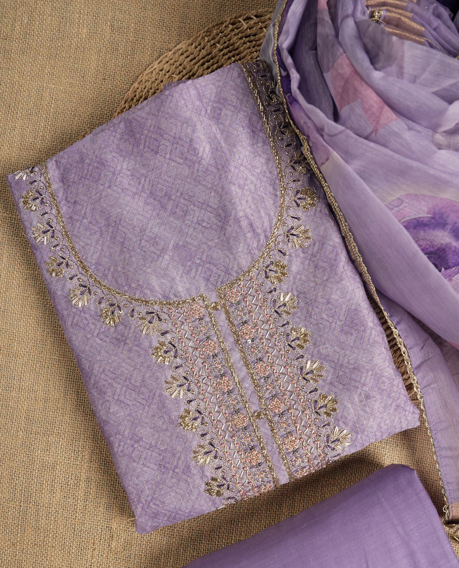 Lavender colour suit material adorned with pearls and cut beads embroidery work on the neckline, exuding a graceful charm & Paired with a floral printed dupatta and a matching plain bottom.