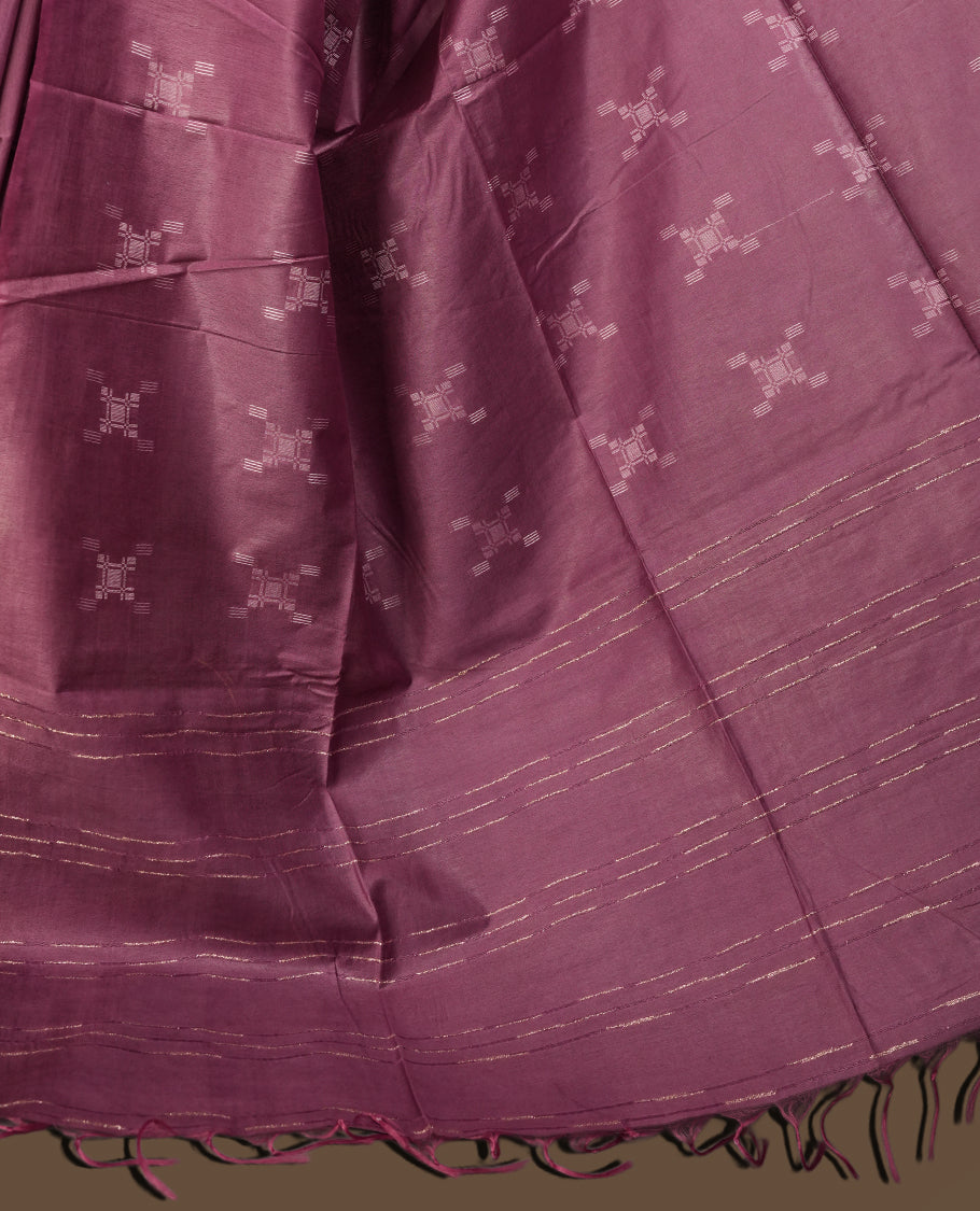 Mauve colour semi jute saree adorned with subtle thread motifs across the body & Features a soft sheen, woven geometric pallu, sleek border, and comes with a matching blouse piece for a graceful ensemble.
