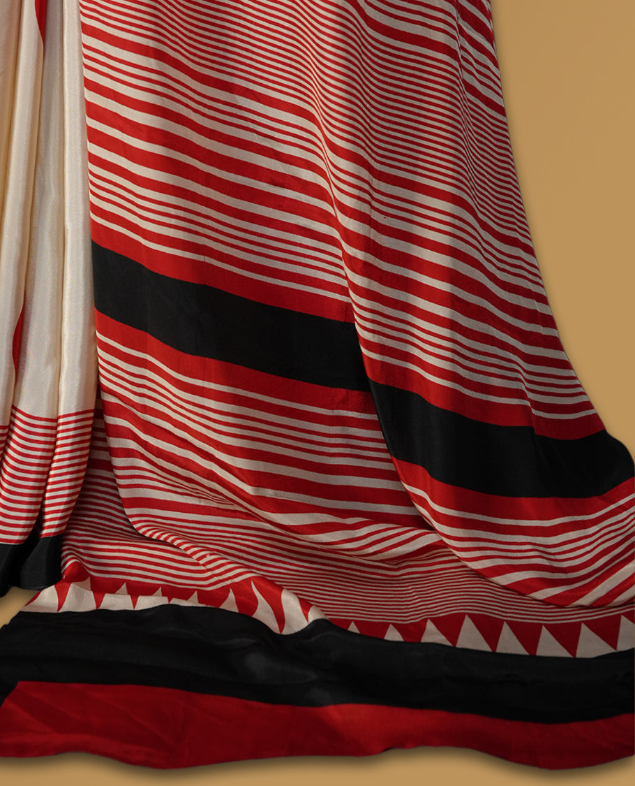 Ivory colour saree with bold red polka dots and contrasting black red striped pallu & Comes with a stylish matching blouse.