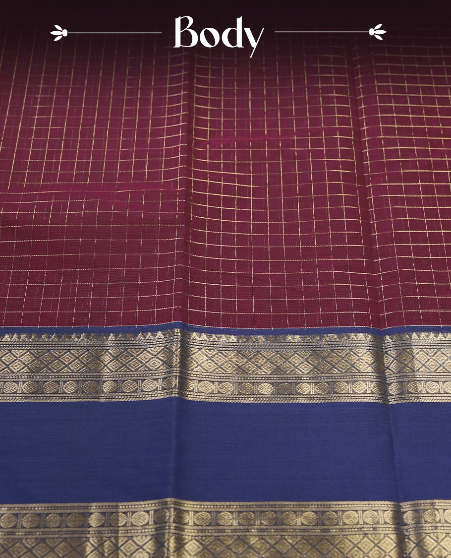 Maroon colour pure Kanchi cotton saree featuring with delicate golden checks on body, paired with a contrasting navy blue zari woven border & Includes a matching blouse piece for a complete look.