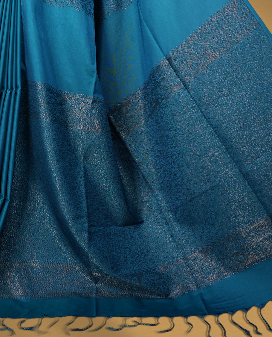Rich Blue colour semi soft silk saree, adorned with subtle self woven motifs on the body & The design is elevated with an elegant zari border and pallu with tassels, paired with a matching blouse.