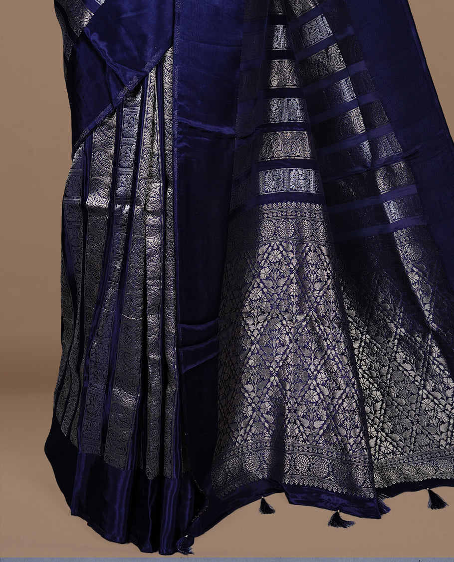 Blue colour banaras crepe saree featuring gold & silver zari design stripes on body, complemented by self colour border, paired with matching blouse piece.