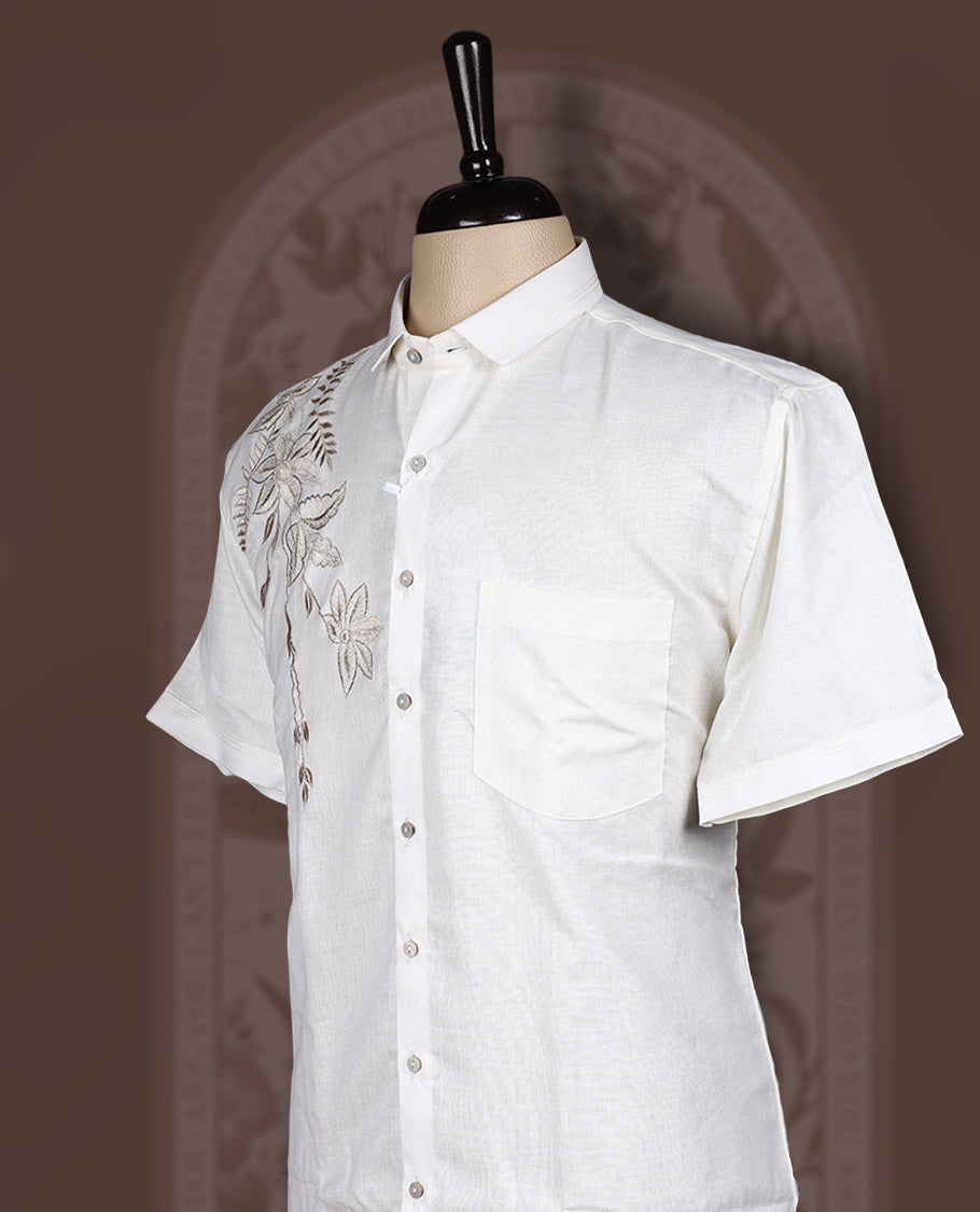 Off White colour cotton linen shirt featuring delicate embroidery work on the shoulder, designed with a mandarin collar and short sleeves for a refined yet comfortable style.
