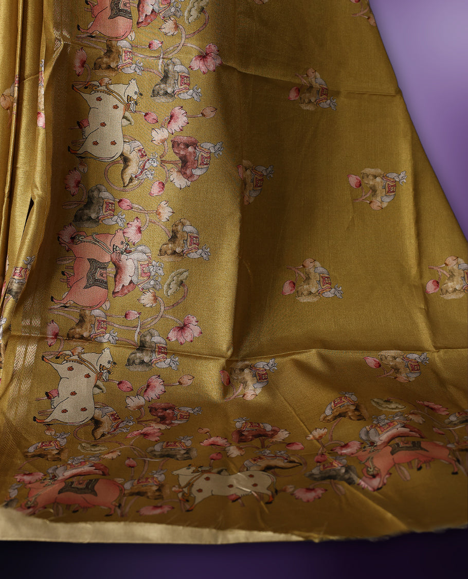 Medallion yellow color saree adorned with charming pastel floral and figure prints all over the body and pallu, lending a whimsical touch & The soft sheen adds elegance, and its paired with a matching blouse piece.