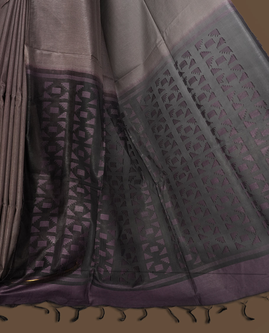 Grey brown colour semi jute saree featuring fine striped body work for a subtle texture, Accented with a geometric woven purple shaded pallu, sleek border, soft drape, and a matching blouse piece for a complete look.