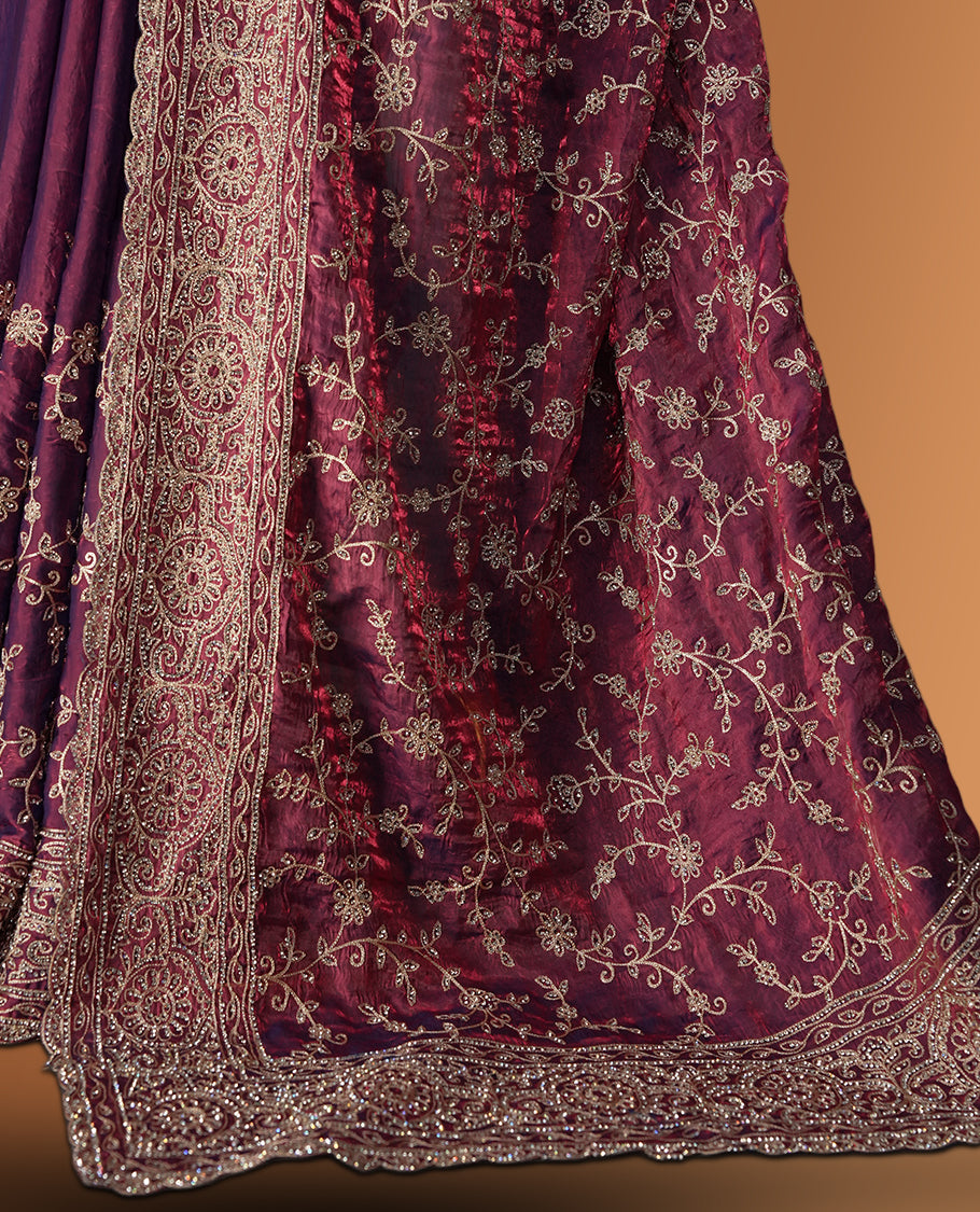 Purple colour velvet chiffon designer saree in elegant two tone shades, featuring light gold zari, kodi work with handwoven style thread embroidery, Swarovski stone work and all over motifs, comes with matching blouse.