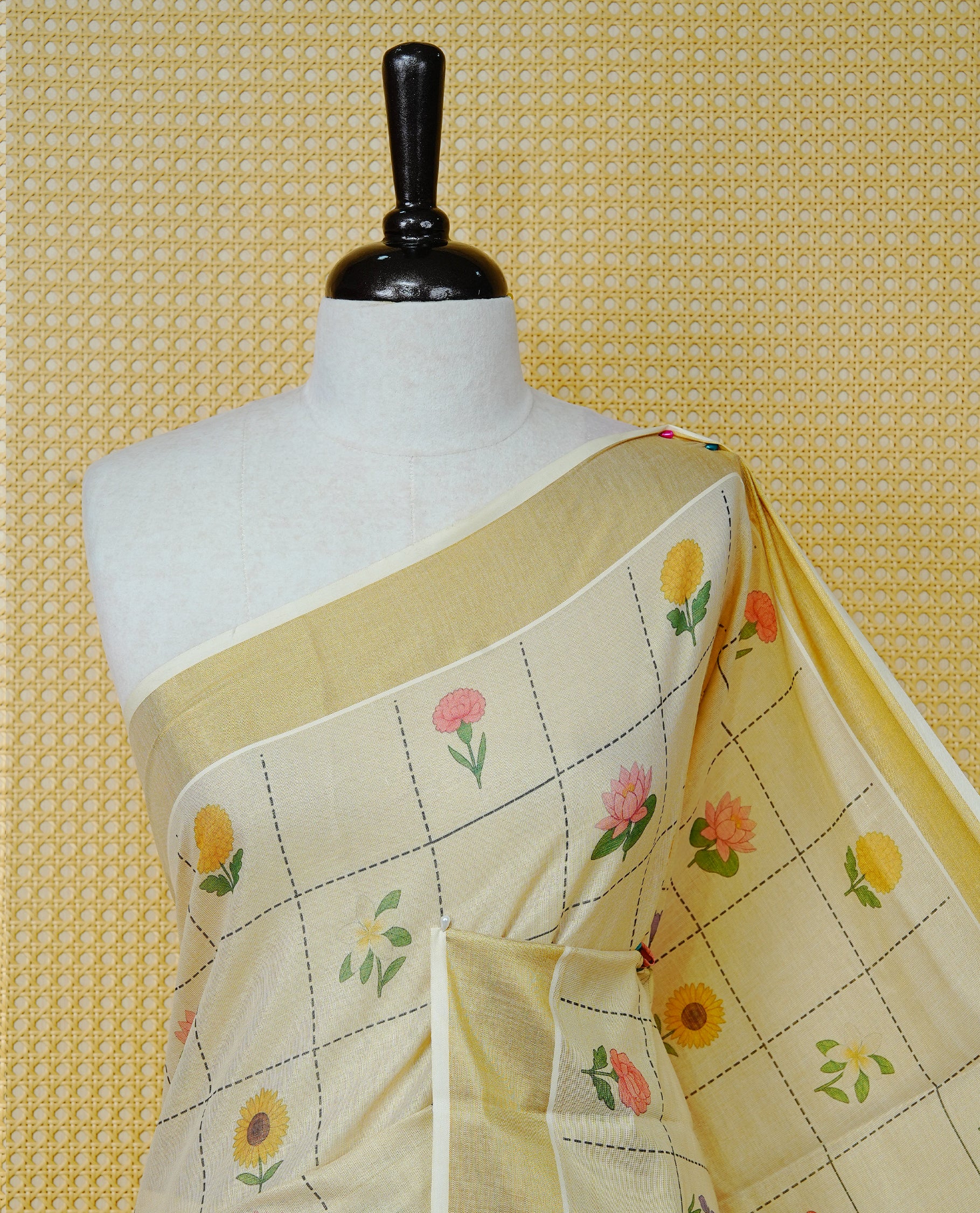Cream Colour Tissue Kerala Saree Featuring Multicolour Floral Motifs In A Checked Pattern Across The Body, Enhanced With A Gold Zari Border And A Traditional Gold Zari Pallu, Finished With A Matching Blouse Piece