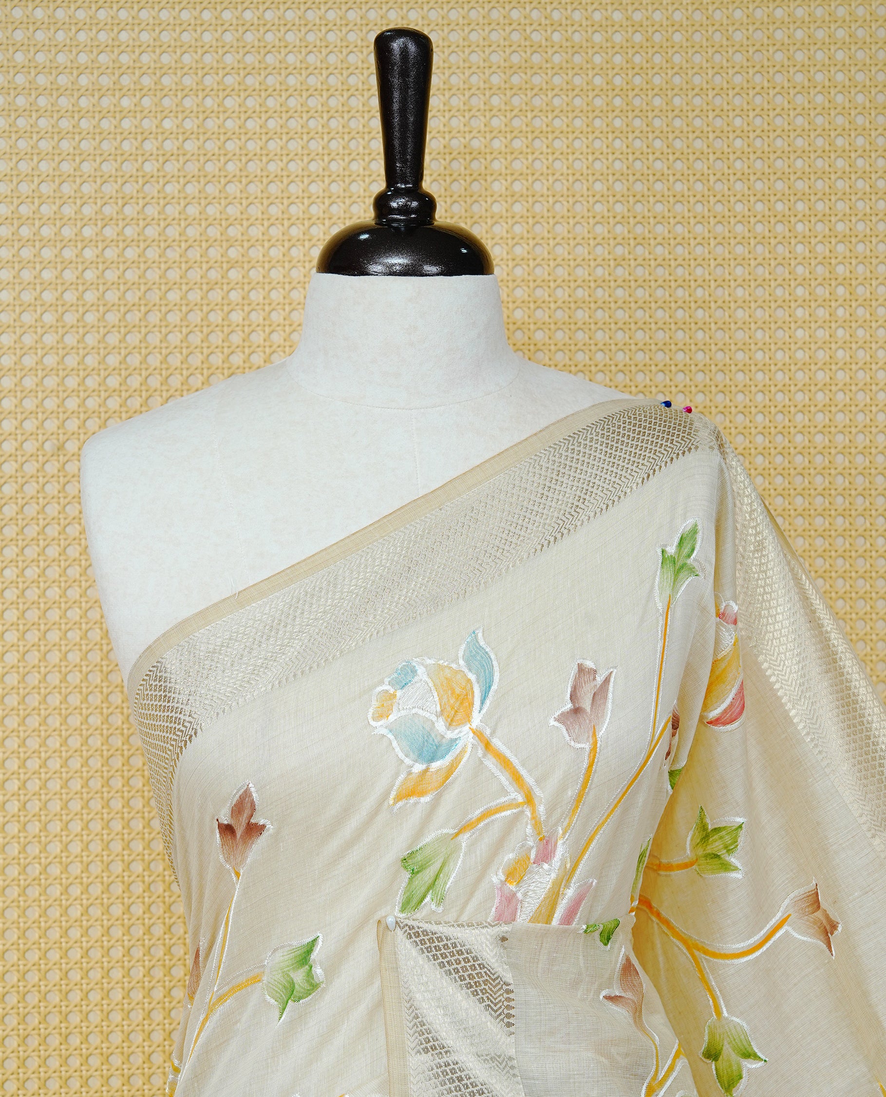 Cream Colour Tissue Kerala Saree Featuring Floral Kodi Threadwork Across The Body, Enhanced With A Light Gold Zari Border And A Yellow Floral Pallu, Finished With Gold Tassels And A Matching Blouse Piece