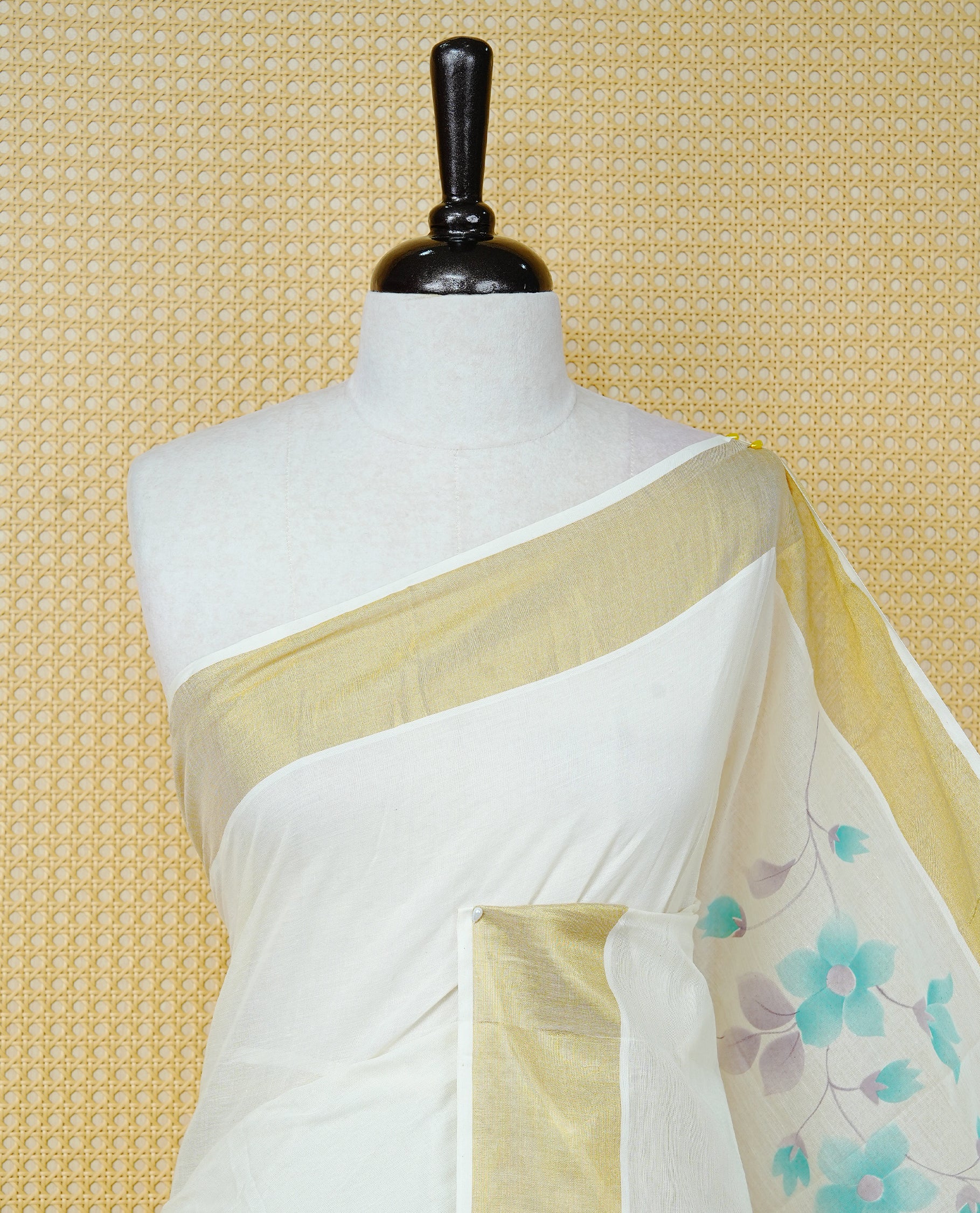 Cream Colour Cotton Kerala Saree Featuring Digital Floral Prints Across The Body, Enhanced With A Gold Zari Border, Traditional Gold Zari Pallu, Finished With Mint & White Tassels And A Matching Blouse Piece